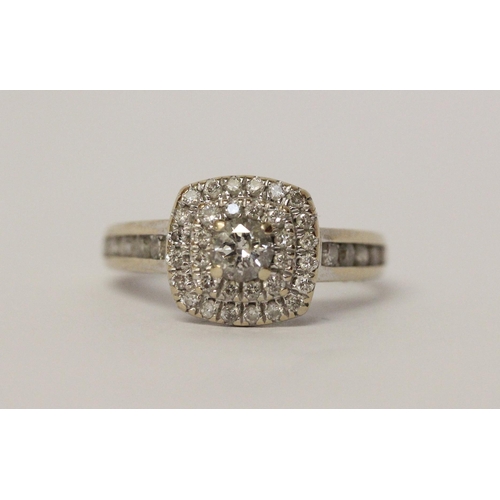 644 - A modern diamond halo cluster ring, diamond set shoulders, in hallmarked 18ct white gold, marked in ... 