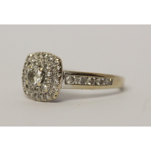 644 - A modern diamond halo cluster ring, diamond set shoulders, in hallmarked 18ct white gold, marked in ... 