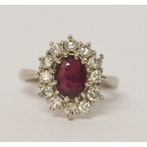 658 - A large ruby and diamond oval cluster ring, the ruby weighing approximately 1.5 carats and diamonds ... 