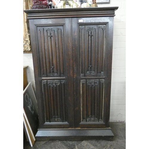 213 - A reproduction oak linen fold panel two door cabinet, 3' wide