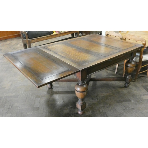 60 - An oak drawer leaf dining table on bulbous legs with cross stretchers, with leaves in it is 4'3 x 3'... 