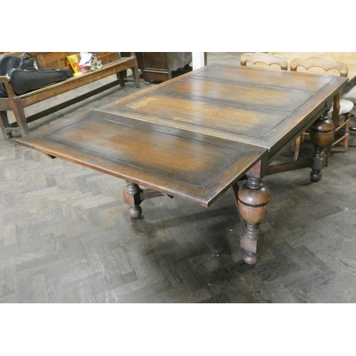 60 - An oak drawer leaf dining table on bulbous legs with cross stretchers, with leaves in it is 4'3 x 3'... 