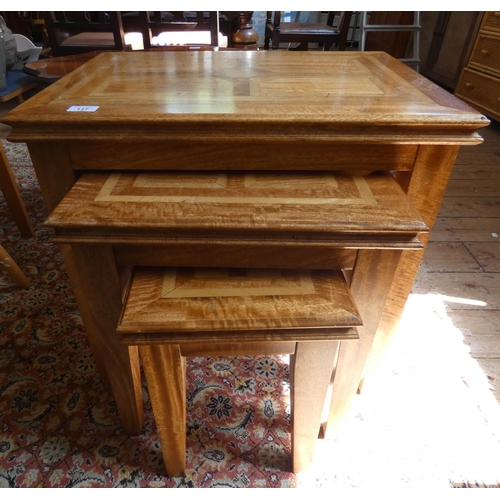 117 - A nest of three Spanish style parquetry inlaid coffee tables of graduated size