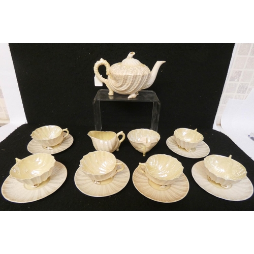 160 - A Belleek lustre glazed shell shaped tea service, six cups, six saucers, milk jug, shell shaped teap... 