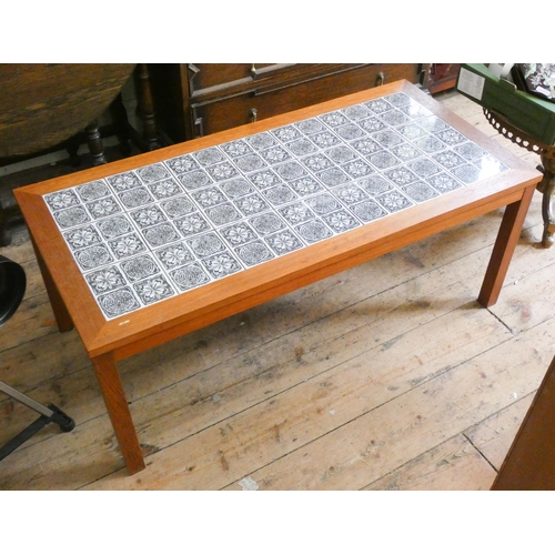 27 - A long teak coffee table with inset tiled top