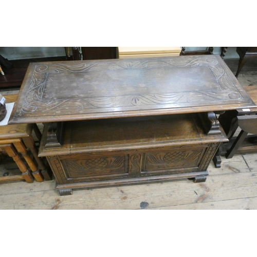 37 - A carved oak Monks bench with fold over top and lion ends, 3'6 wide