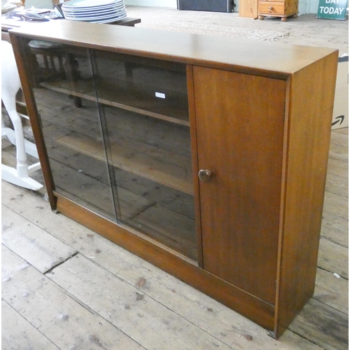 69 - A teak glazed bookcase with sliding doors and cupboard one end, 4' wide