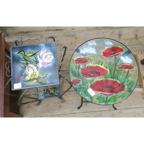 7 - A small circular iron and glass table with floral top and a two tier iron and floral tile plant stan... 