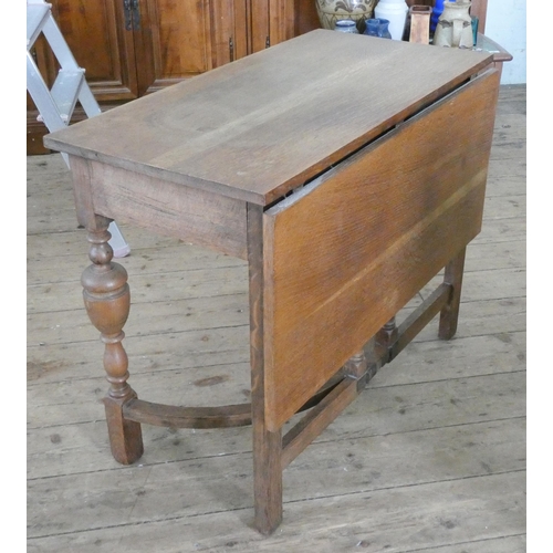 89 - An oak single flap drop leaf table, fitted drawer on stretcher style base, 3' wide