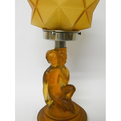 155 - Art Deco pressed amber glass table lamp modelled as a nude supporting a star shaped shade