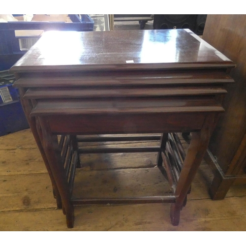 128 - A nest of four mahogany coffee tables, the smallest of which has fitted drawer