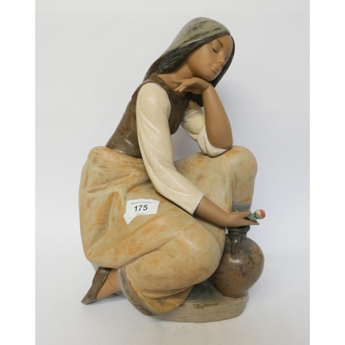 175 - A large Lladro figurine of a girl holding a rose, numbered on base 30502