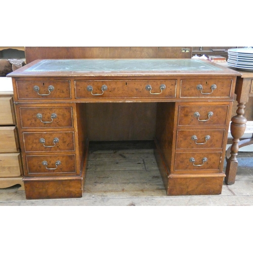 88 - A Georgian style figured walnut twin pedestal kneehole desk fitted nine drawers with green leather t... 