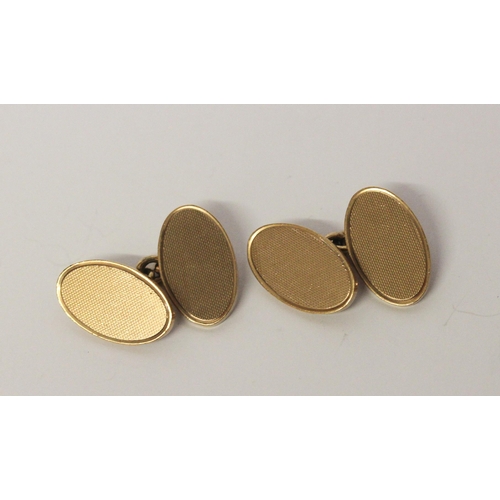 450 - A pair of 9ct gold oval cufflinks with engine turned decoration, hallmarked 13.9gms