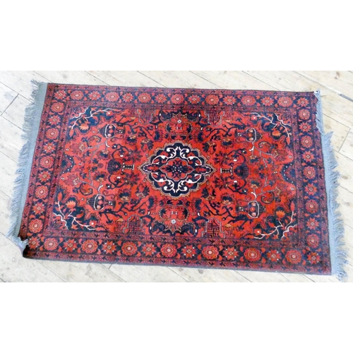 274 - A red and patterned Persian rug, 5'6 x 3'3