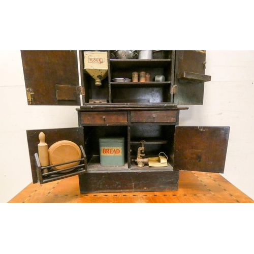 297 - A late Victorian stained child's/dolls dresser, fitted cupboards, shelves and two drawers together w... 