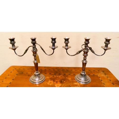 416 - A pair of silver plated three branch candelabra