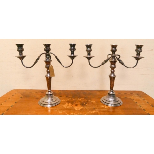 416 - A pair of silver plated three branch candelabra