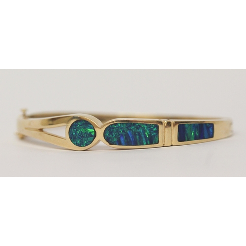 486 - A modern 14k yellow gold opal set hinged bangle, marked 14k,  gross weight 26.7 g