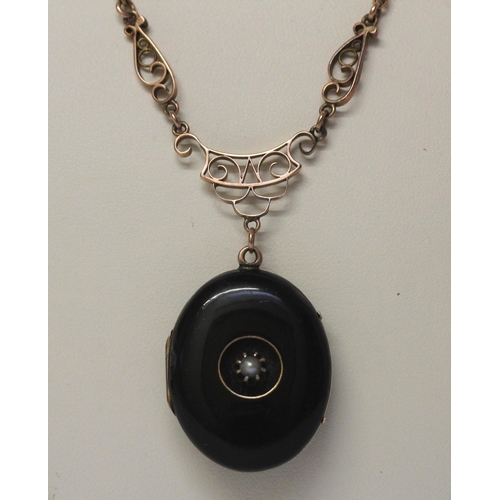 490 - Victorian oval black enamel and seed pearl set mourning locket, suspended from a 9ct rose gold neckl... 