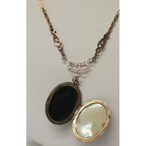 490 - Victorian oval black enamel and seed pearl set mourning locket, suspended from a 9ct rose gold neckl... 