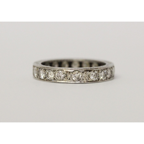 492 - A vintage diamond eternity ring, in unmarked white precious metal, fully set with diamonds. Ring siz... 