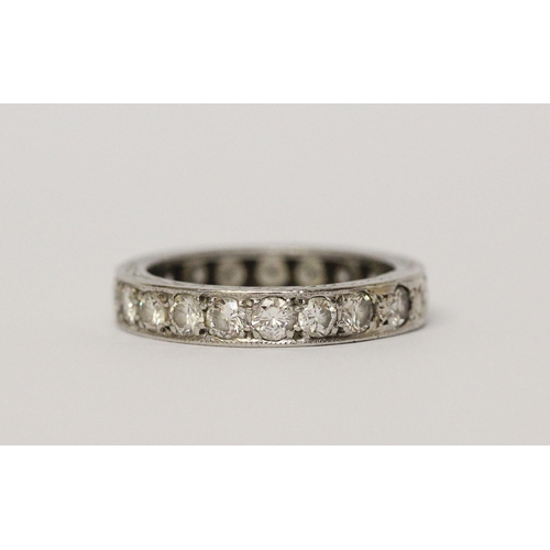 492 - A vintage diamond eternity ring, in unmarked white precious metal, fully set with diamonds. Ring siz... 