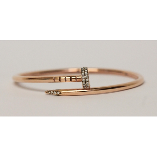 505 - In the style of Cartier Juste un clou rose gold bangle, set with diamonds. 14ct rose gold marked 'Ca... 