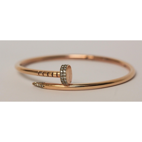 505 - In the style of Cartier Juste un clou rose gold bangle, set with diamonds. 14ct rose gold marked 'Ca... 