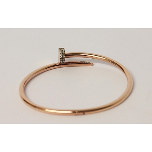 505 - In the style of Cartier Juste un clou rose gold bangle, set with diamonds. 14ct rose gold marked 'Ca... 