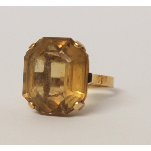 509 - A citrine single stone statement dress ring. Oval citrine within claw setting to yellow gold band ma... 