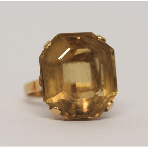 509 - A citrine single stone statement dress ring. Oval citrine within claw setting to yellow gold band ma... 