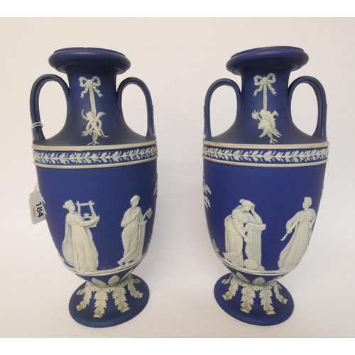 184 - A Pair of Wedgwood Jasper Ware Vases, dipped in deep blue jasper and ornamented with the muses, the ... 