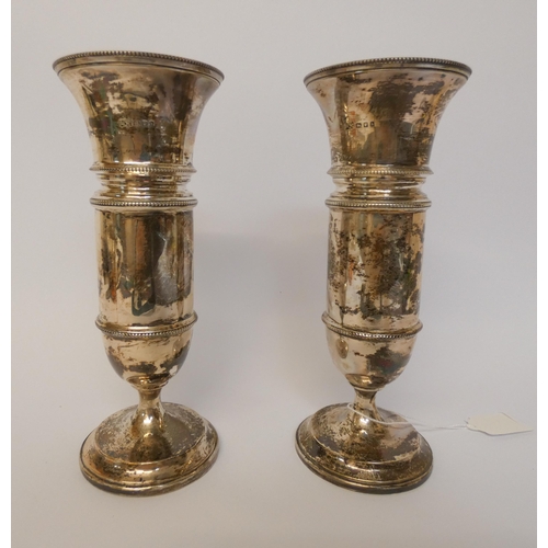 417 - A pair of silver vases, on weighted circular feet with tortoiseshell bases. London marks 1923. 18cms... 