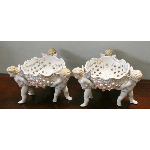 187 - Large pair matching Dresden style pierced centrepiece bowls supported by cherubs, 22cms tall