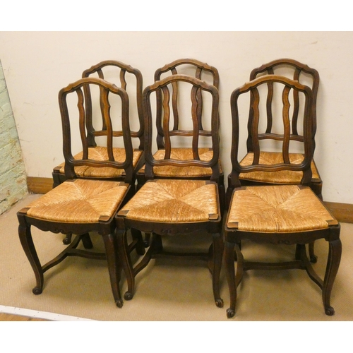 210 - A set of six French oak dining chairs with rush seats on cabriole legs with cross stretchers