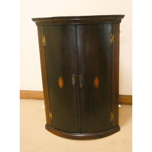 263 - A Georgian shell inlaid mahogany bow front hanging corner cupboard, fitted two doors with interior s... 