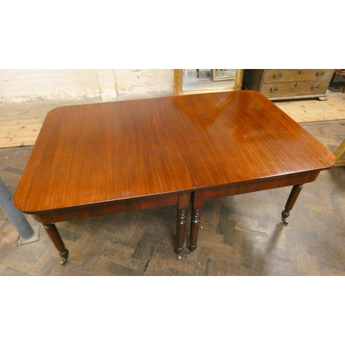 269 - A Georgian mahogany extending dining table with centre leaf standing on turned legs, 79