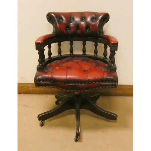 276 - A Captains style revolving mahogany office elbow chair with red buttoned leather upholstered seat an... 