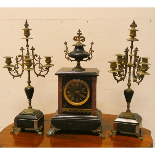 279 - A French black marble three piece clock garniture, comprising striking mantle clock and a pair of br... 