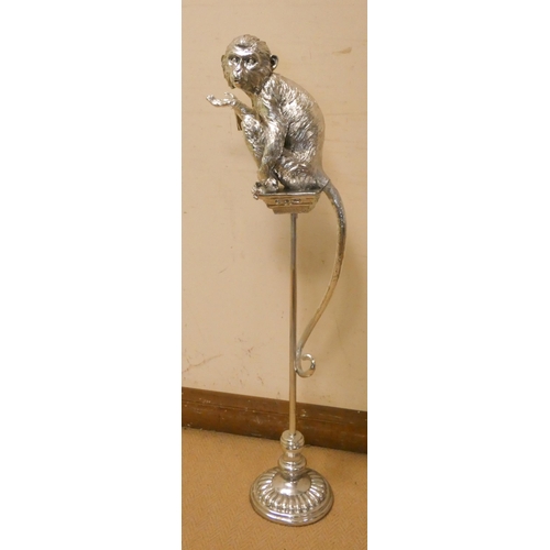 281 - A silver decorated monkey on pedestal, 42