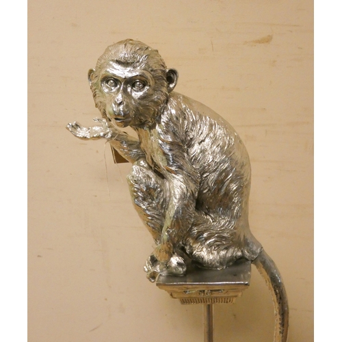 281 - A silver decorated monkey on pedestal, 42