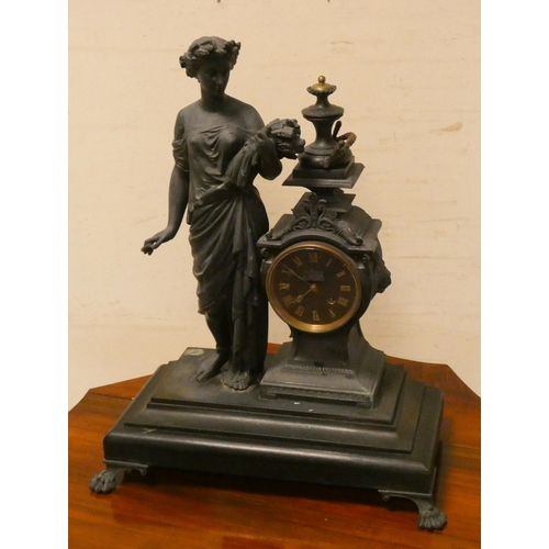 291 - A French figure decorated striking mantle clock on ebonised base with brass feet, 20