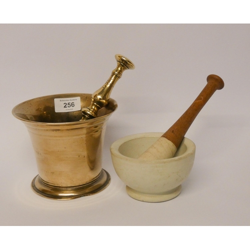 256 - A brass pestle and mortar and a ceramic pestle and mortar