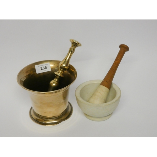 256 - A brass pestle and mortar and a ceramic pestle and mortar