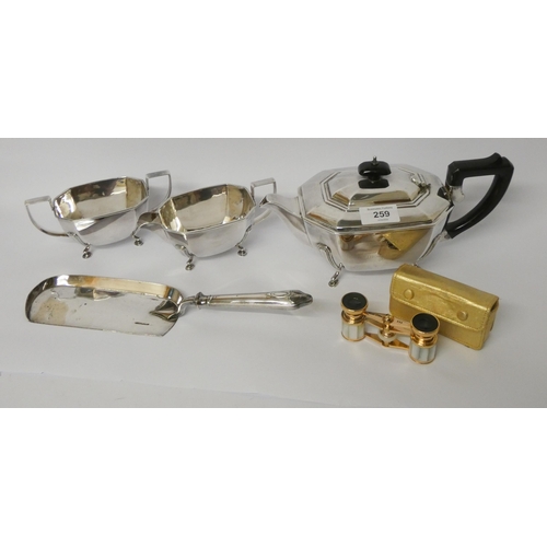 259 - A three piece silver plated vintage tea service, crumb scoop and a pair of opera glasses with case