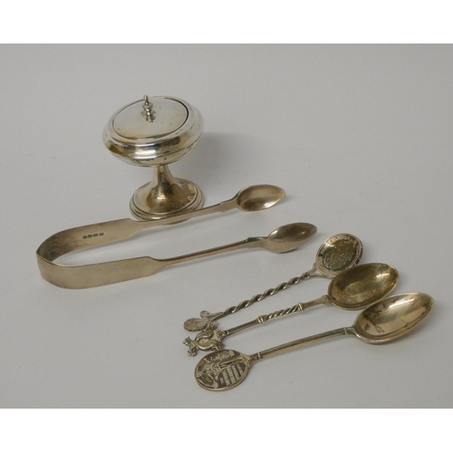 436 - A pair of hallmarked silver sugar nips, three silver spoons and a silver dressing table jar