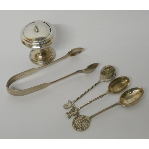 436 - A pair of hallmarked silver sugar nips, three silver spoons and a silver dressing table jar