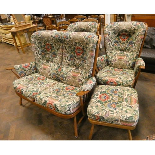 201 - An Ercol wood framed two seater settee three piece suite with floral tapestry style covers together ... 