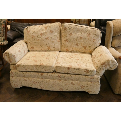 202 - A small two seater drop end settee in cream and floral figured covering